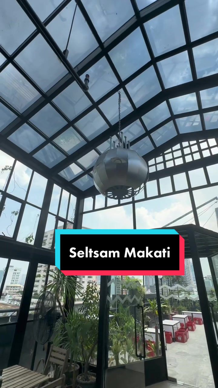 Seltsam glass ceiling structure with hanging light and city view