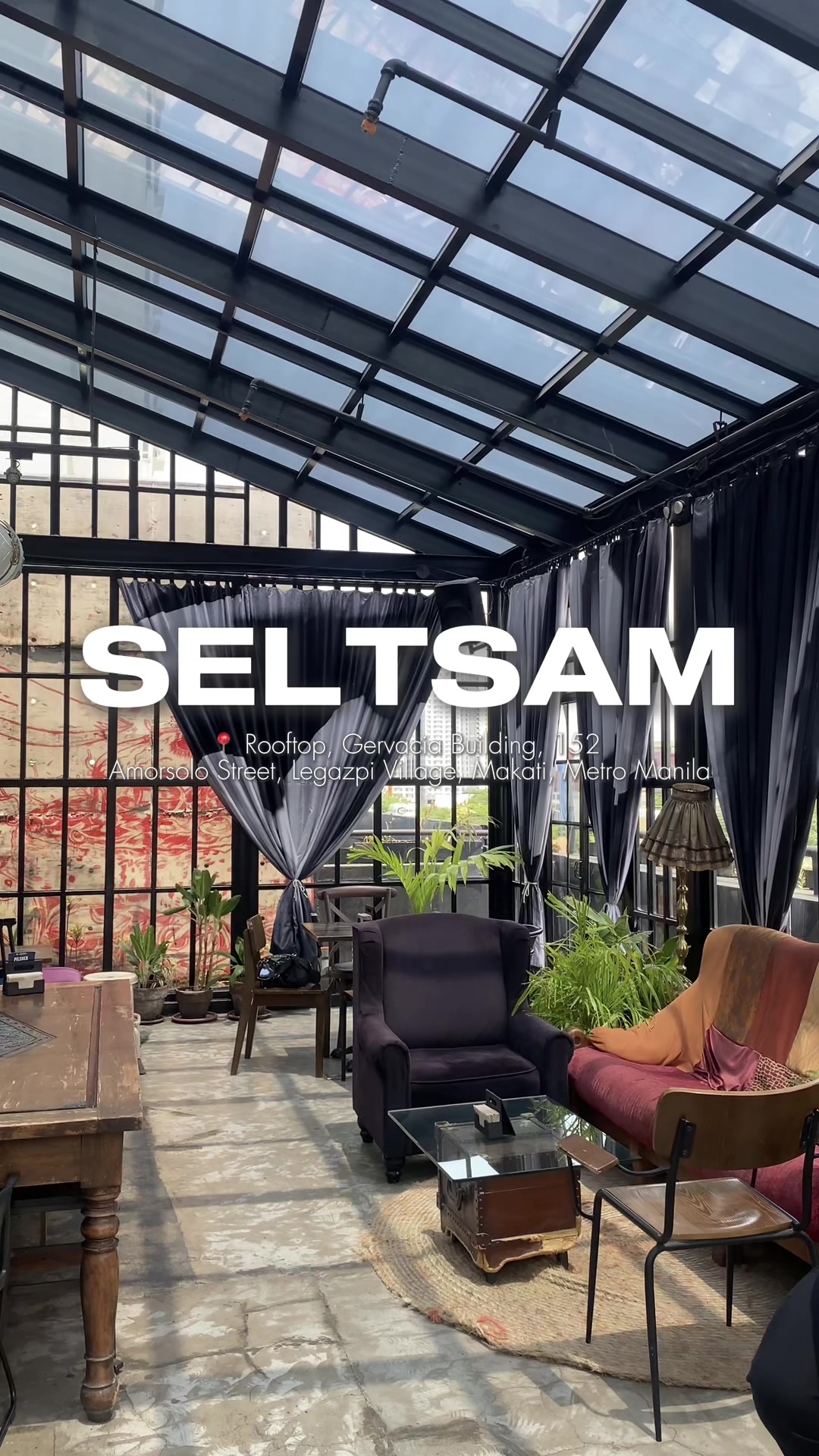 Seltsam interior wide view with vintage furniture and glass walls overlooking Makati